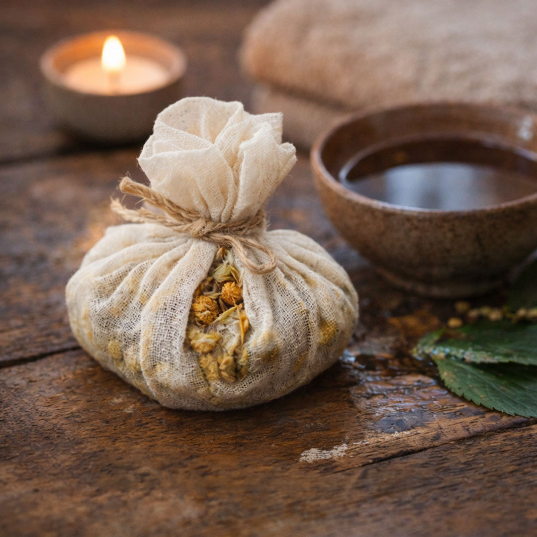 Herbal bag tied with twine on a wooden surface with a candle and bowl in the background